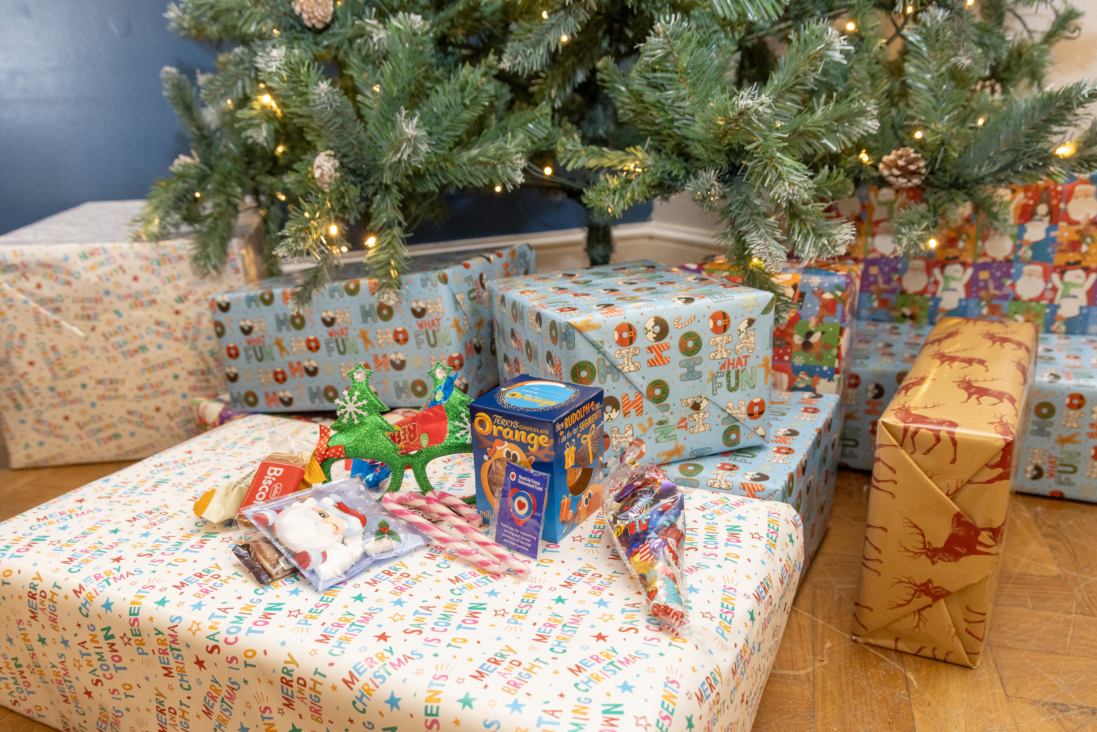 Photo - Wrapped Christmas boxes placed under a Christmas tree